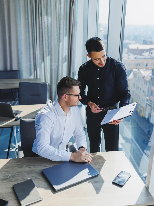 two-business-men-are-creating-project-while-looking-laptop-screen-during-meeting-modern-boardroom-work-process-modern-office